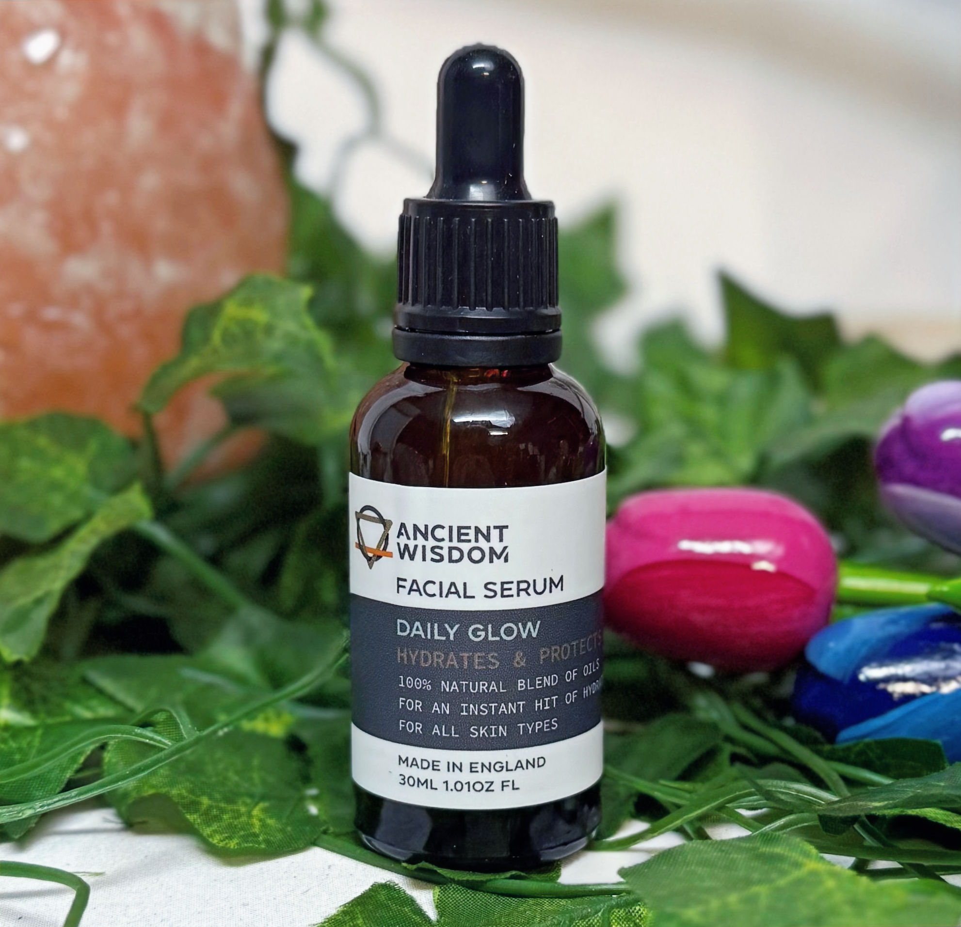 Glass jar with pipette lid with sticker that says "daily glow oil facial serum"