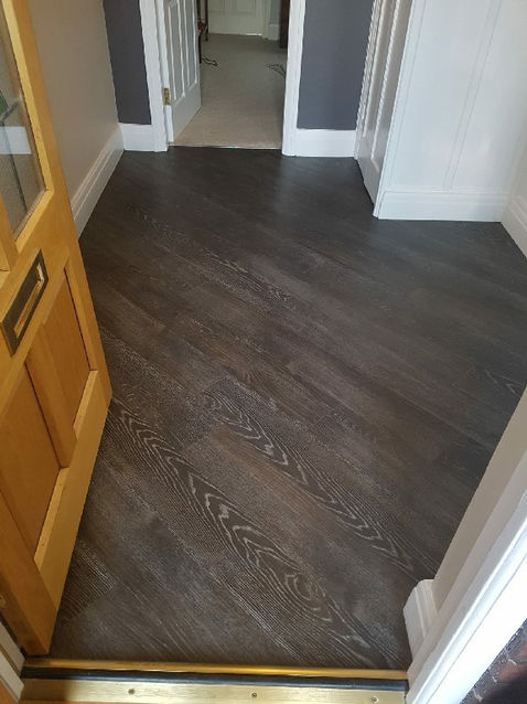 Dark gray LVT flooring in a hallway