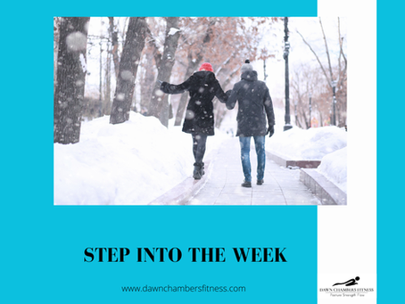 Two people walk hand in hand on a snowy path, surrounded by trees and falling snow. Text reads "STEP INTO THE WEEK" with a website link.