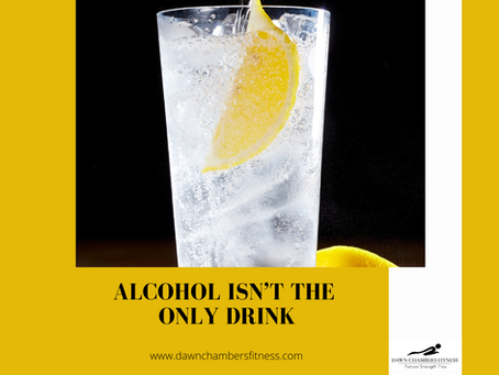 Glass of sparkling water with a lemon slice, set against a black background. Text reads "ALCOHOL ISN’T THE ONLY DRINK" on a yellow border.