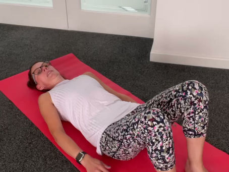 lady on the floor doing spine twist exercise