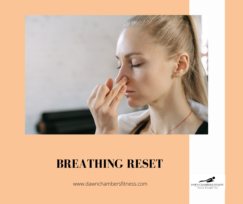 Woman practicing breathing exercise, pinching one nostril. Text: "Breathing Reset", "dawnchambersfitness.com". Calm background.