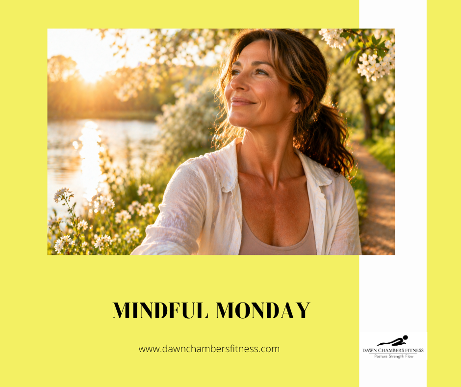 Woman smiling in a sunlit park with blooming trees by a river. Text reads "Mindful Monday" and "www.dawnchambersfitness.com".