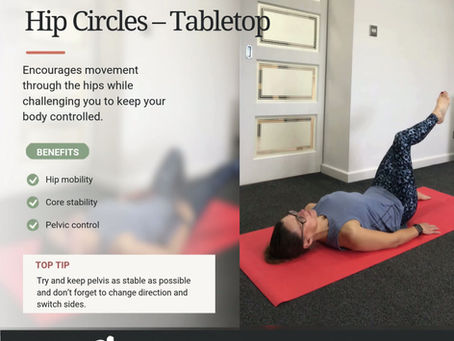 a lady doing the pilates move "hip circles" on a red mat