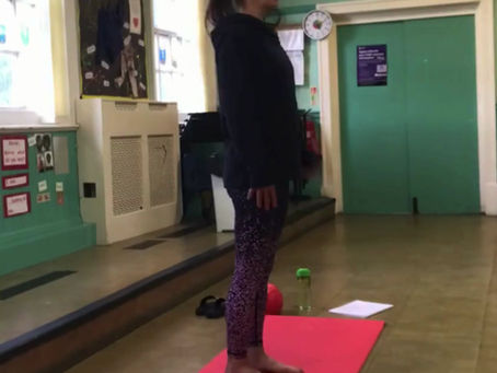 a lady doing pilates in a school hall