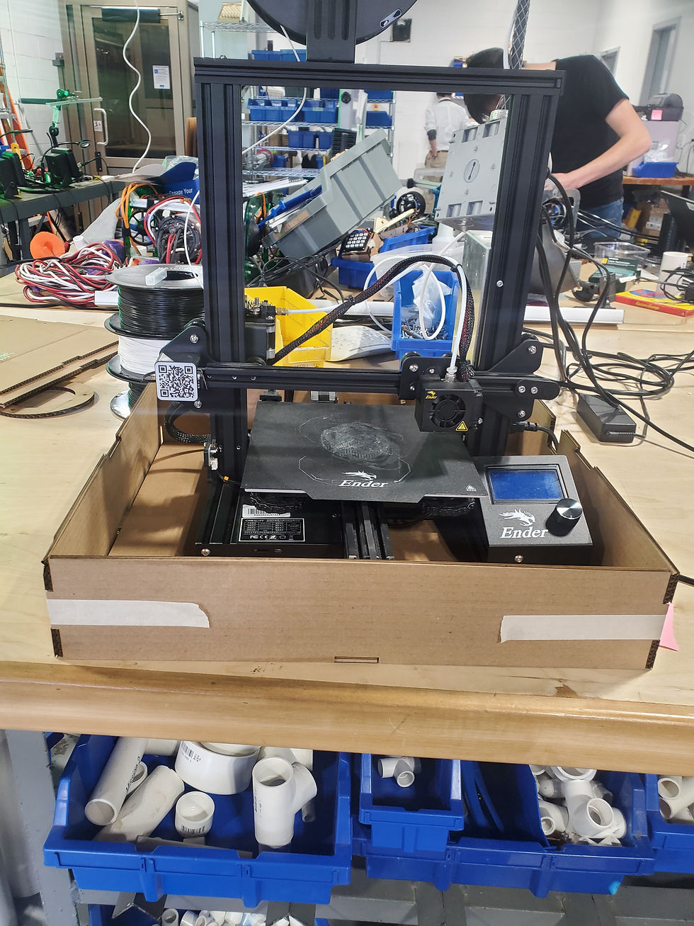 The 3D printer w/ the test cut of the bottom part of the case.