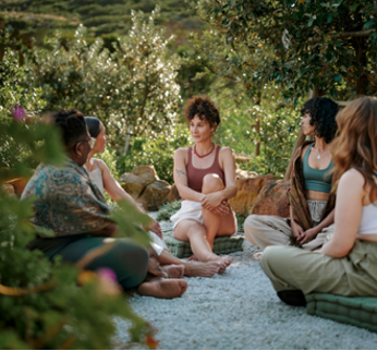 Women sat in a circle outside