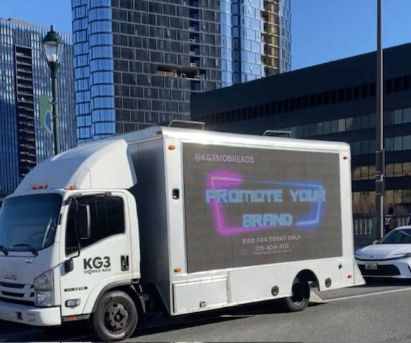mobile billboard truck advertising during sporting game.