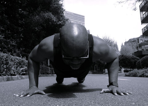 A close up of Addo the Coach doing a push up outside.