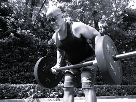 Addo the Coach doing a focused bent over row with an axel bar.
