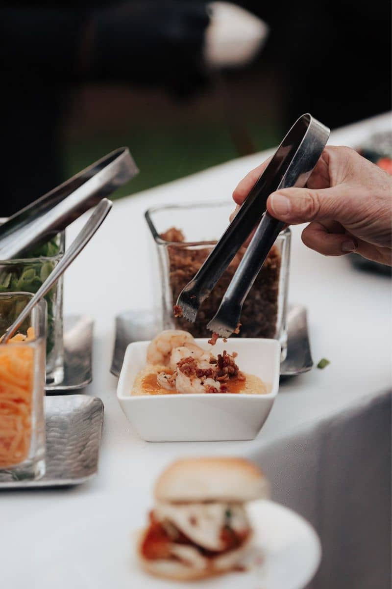 a bowl of shrimp and grits at a wedding buffet, showcasing the high-quality and customizable caterin