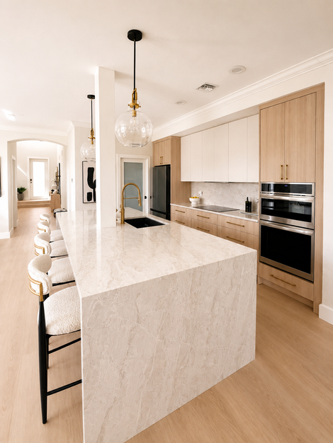 Custom kitchen renovation with light oak cabinetry, integrated appliances, quartz countertops, and clean modern detailing.