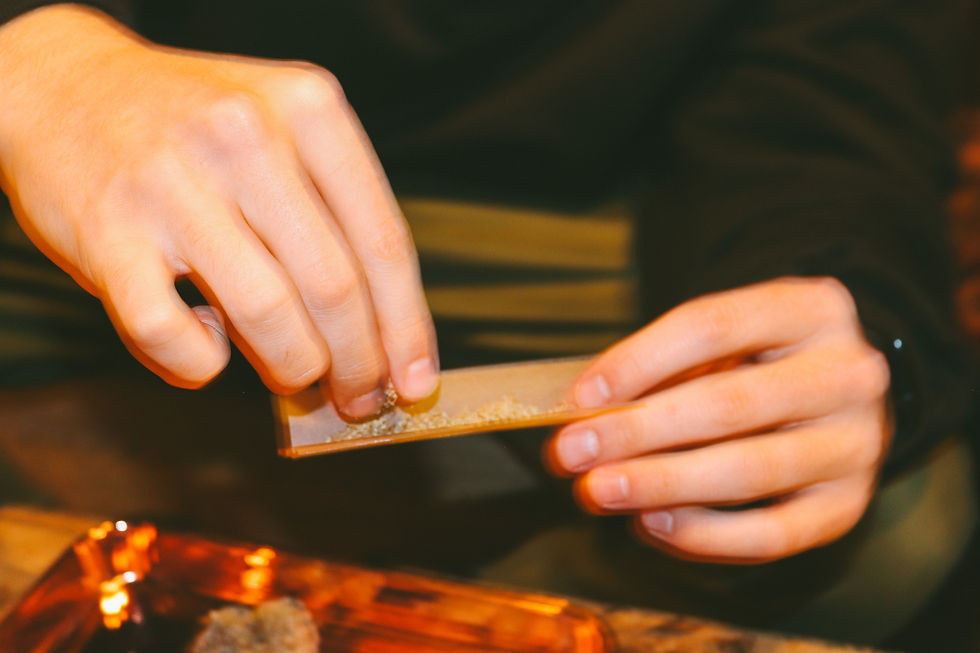 two male hands rolling a joint