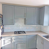 Modern kitchen with light blue cabinets, stainless steel appliances