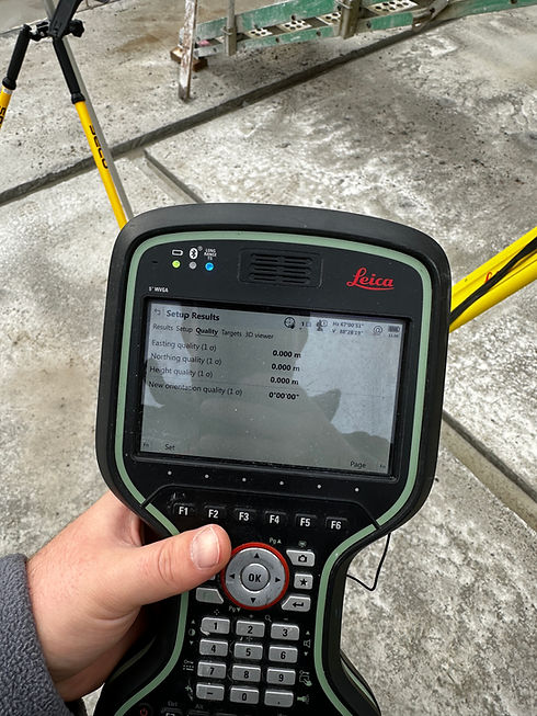 Handheld digital land surveying data collector being used on an outdoor construction site