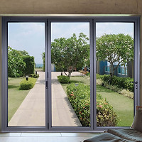 View through large glass doors showing a garden path lined