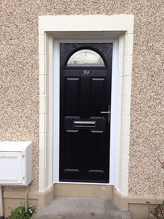 A sleek black door with a half moon window