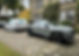 Two SUVs parked side by side on a brick driveway, showcasing a neat and organized outdoor space