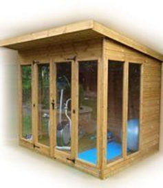 Sunningdale wooden garden room with pent roof and glass windows used as a home gym with an elliptical trainer