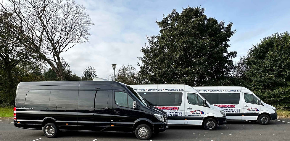Black minibus parked alongside white minibuses from the fleet outdoors