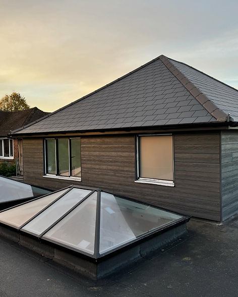 Large grey contemporary roof lantern skylight installed on a flat roof extension