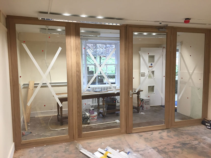 Glass office wall with wooden frames