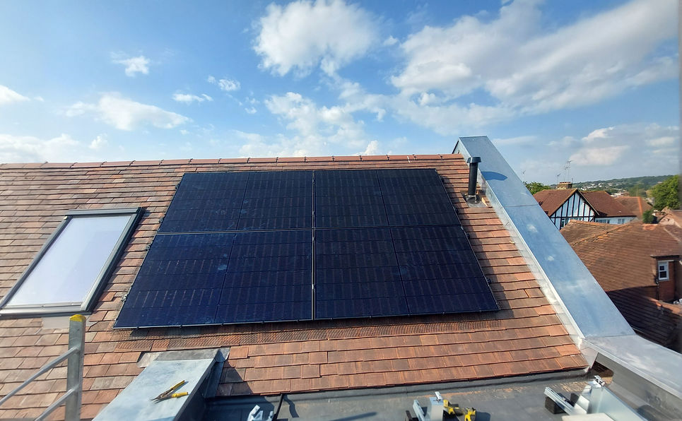 Rooftop with solar panels installed, surrounded by a clear blue sky with scattered clouds