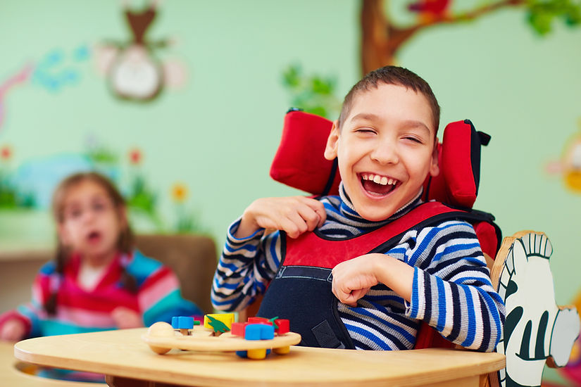 cheerful boy with disability at rehabilitation center for kids with special needs