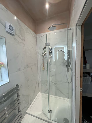 Modern bathroom featuring a glass-enclosed corner shower