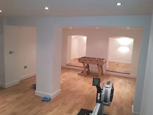 interior of a room with light blue walls and warm wooden flooring