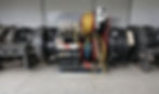 Industrial equipment with coiled cables in red, blue, and yellow dominates the center