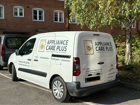 White van parked on a sunny street with "Appliance Care Plus" logo on the side and back