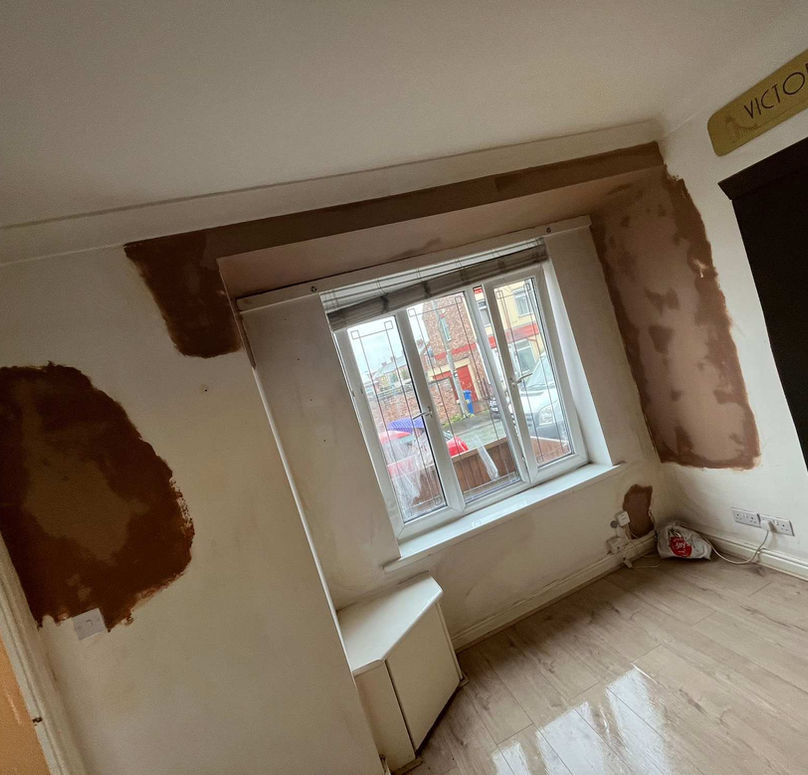 Freshly plastered smooth ceiling in a home hallway with pendant lighting and white staircase woodwork