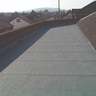 wide gray walkway or path with dark side walls in natural light