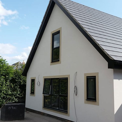 Contemporary house with a gable roof, large windows, and neutral tones