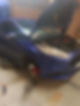 A blue car with its hood open is parked in a garage