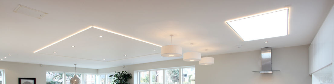Modern interior room featuring three white drum pendant lights and neat recessed ceiling spotlights
