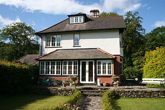 A large house surrounded by a lush garden