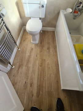 wood effect flooring fitted in a modern bathroom