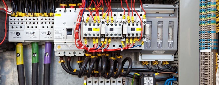 Close up view of structured electrical wiring and multi-coloured cables connected inside a consumer unit