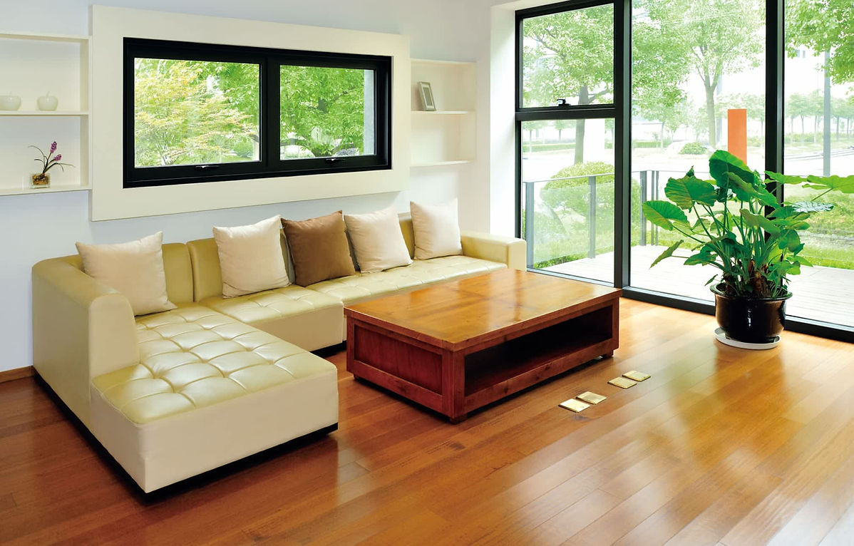 Room with cream sofa, table and plant