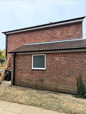 Small white double glazed window installed on a red brick house wall