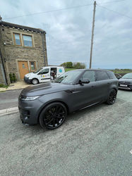 Grey Tesla Model Y after exterior cleaning on a residential street