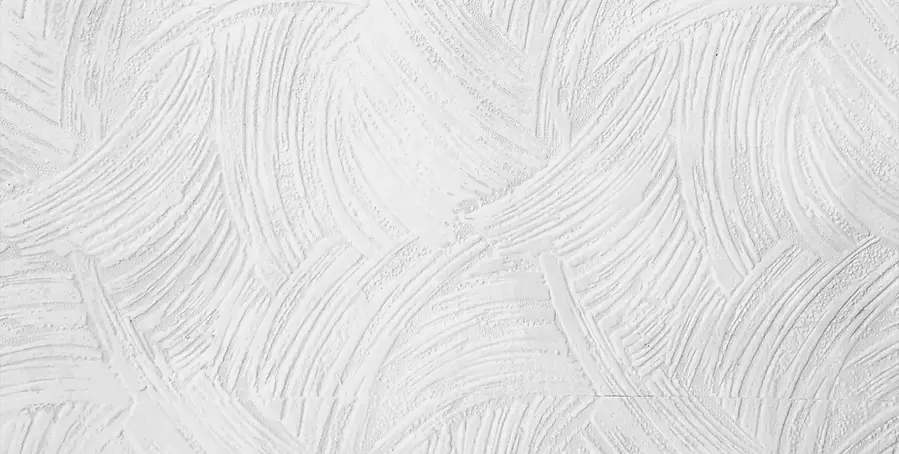 close up view of a white textured plaster surface with sweeping swirl patterns