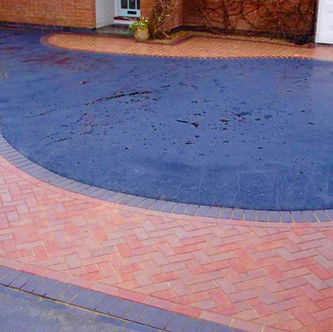 Curved red and charcoal block paved driveway