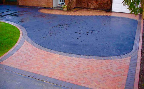 A driveway featuring a brick path and brick pavers, showcasing a well-maintained outdoor space