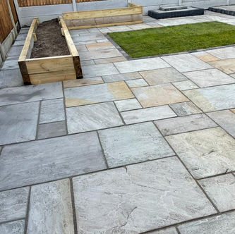 Natural stone patio with raised planter beds