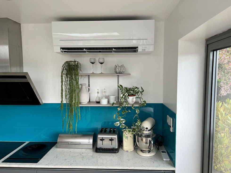 Gloss white Mitsubishi air conditioning unit installed in a kitchen above decorative wall shelving