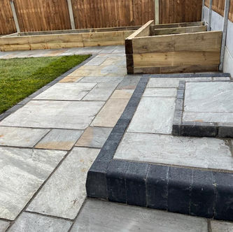 Natural stone patio with raised seating area