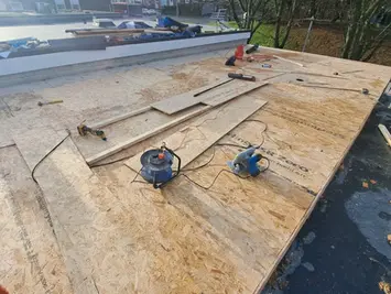 Flat roof deck prepared for waterproof roofing system
